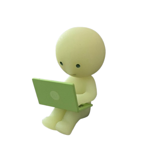Smiski figurine looking at a laptop